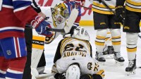 Boston Bruins goalie Jeremy Swayman (1) checks on teammate Boston Bruins defenseman Charlie McAvoy (73) who got hit by a shot in the face during the second period of the game against the Montreal Canadiens at the Bell Centre.