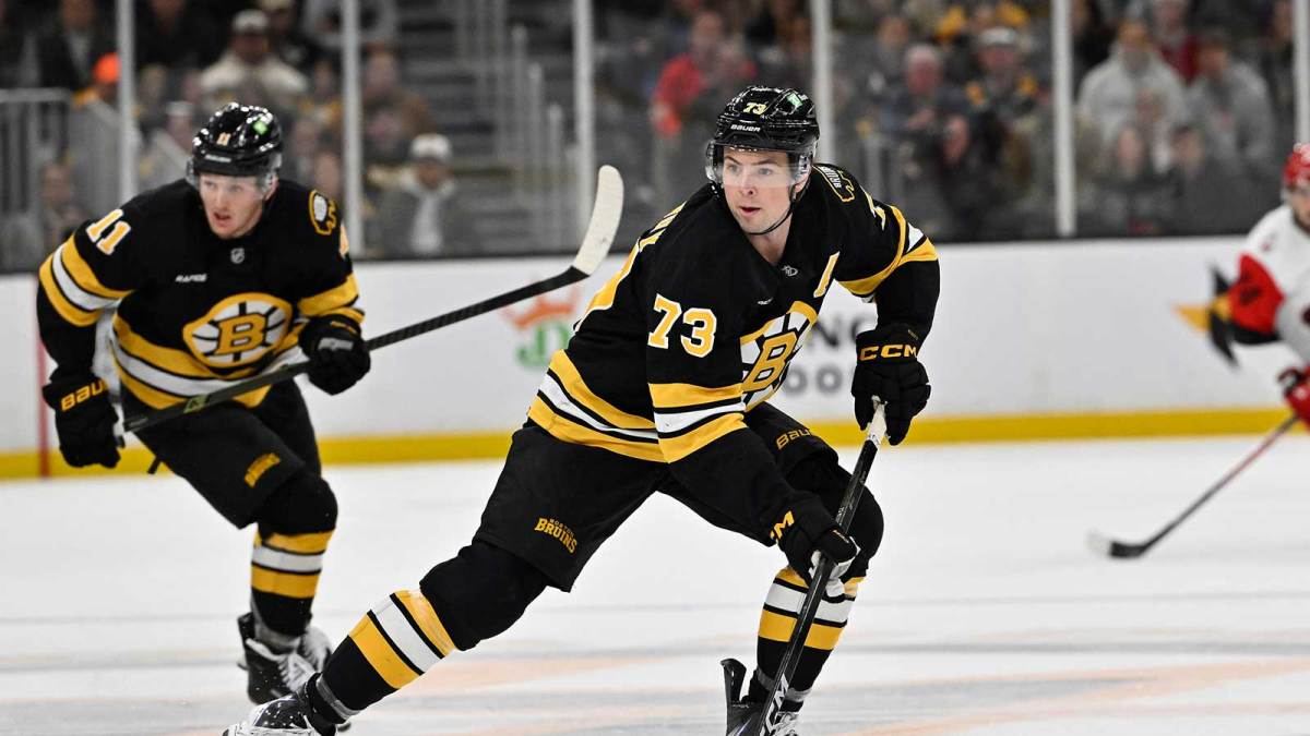 Boston Bruins defenseman Charlie McAvoy (73) skates with the puck during the third period against the Carolina Hurricanes at TD Garden.