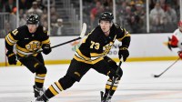 Boston Bruins defenseman Charlie McAvoy (73) skates with the puck during the third period against the Carolina Hurricanes at TD Garden.
