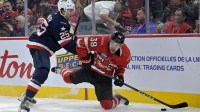 Team Canada forward brandon Hagel (38) plays the puck and Team United States defenseman Charlie McAvoy (25) defends in the second period during a 4 Nations Face-Off ice hockey game at the Bell Centre.