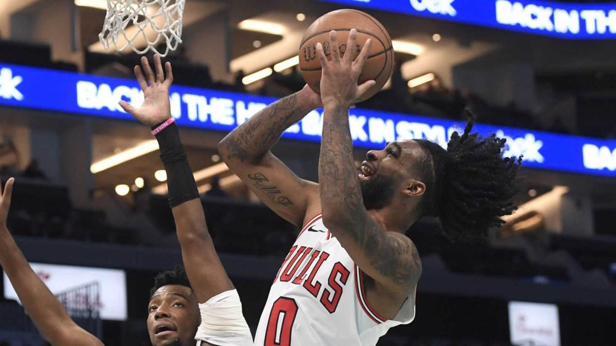 Nov 28, 2025; Charlotte, North Carolina, USA; Chicago Bulls guard Coby White (0) drives in past Charlotte Hornets guard Brandon Miller (24) during the second half at the Spectrum Center. Mandatory Credit: Sam Sharpe-Imagn Images