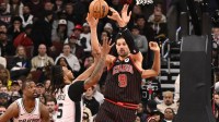 Nov 10, 2025; Chicago, Illinois, USA; Chicago Bulls center Nikola Vucevic (9) passes the ball against San Antonio Spurs guard Stephon Castle (5) during the second half at the United Center. Mandatory Credit: Matt Marton-Imagn Images