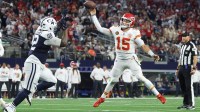 Kansas City Chiefs quarterback Patrick Mahomes (15) throws a pass for a touchdown against Dallas Cowboys defensive tackle Quinnen Williams (92) during the fourth quarter at AT&T Stadium.