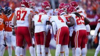 Members of the Kansas City Chiefs offensive squad huddle in the second quarter against the Denver Broncos at Empower Field at Mile High.