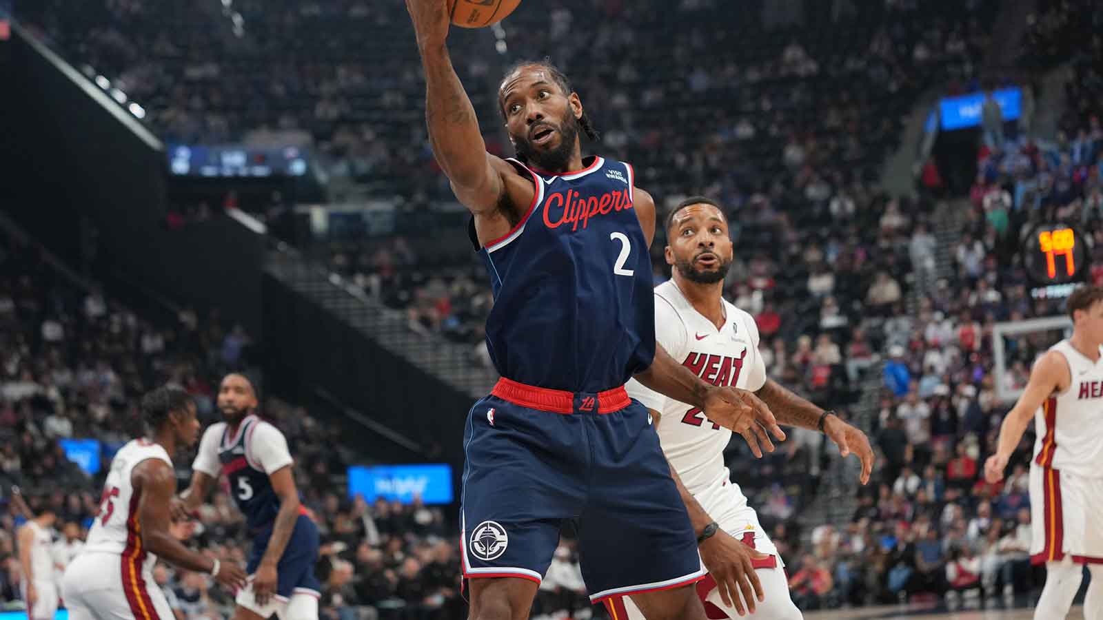 LA Clippers forward Kawhi Leonard (2) reaches for the ball against Miami Heat guard Norman Powell (24) in the first half at Intuit Dome.