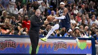 Dallas Mavericks guard Brandon Williams (10) leaps to keep the ball inbounds in front of LA Clippers head coach Tyronn Lue during the second half in an NBA Cup game at the American Airlines Center.