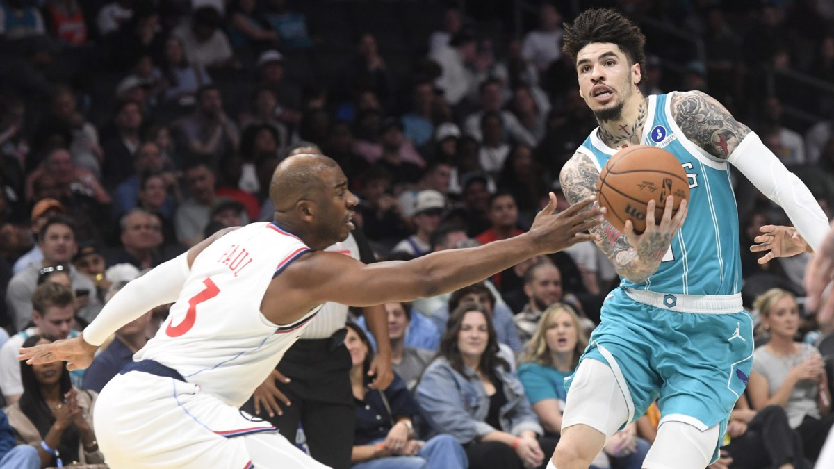 Hornets guard LaMelo Ball (1) drives past Los Angeles Clippers guard Chris Paul (3) during the first half at the Spectrum Center