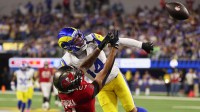 Los Angeles Rams cornerback Cobie Durant (14) breaks up a pass intended for Tampa Bay Buccaneers wide receiver Emeka Egbuka (2) during the first quarter at SoFi Stadium.