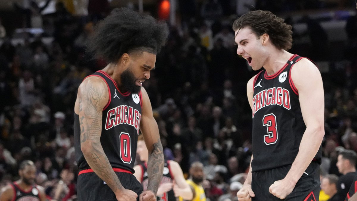 Chicago Bulls guard Coby White (0) celebrates his three point basket against the Los Angeles Lakers with guard Josh Giddey (3) during the second half at United Center.