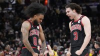 Chicago Bulls guard Coby White (0) celebrates his three point basket against the Los Angeles Lakers with guard Josh Giddey (3) during the second half at United Center.