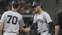 New York Yankees right fielder Cody Bellinger (35) celebrates with first base coach Travis Chapman after hitting a single during the fifth inning against the Houston Astros at Daikin Park.