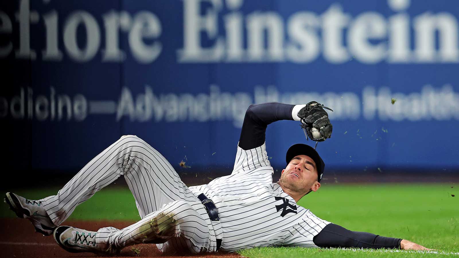 New York Yankees left fielder Cody Bellinger (35) slides to makes a catch during the first inning against the Toronto Blue Jays during game four of the ALDS round for the 2025 MLB playoffs at Yankee Stadium. 