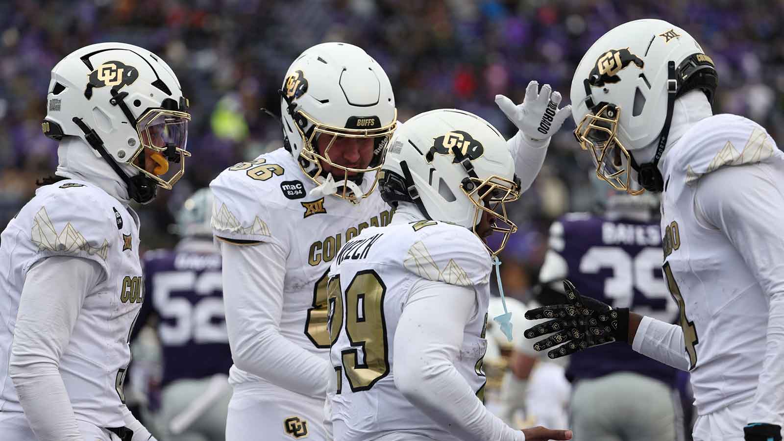 Colorado Buffaloes running back Micah Welch (29) is congratulated by teammates after scoring a touchdown in the fourth quarter against the Kansas State Wildcats at Bill Snyder Family Football Stadium.