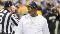 Colorado Buffaloes head coach Deion Sanders walks along the sidelines late in the fourth quarter against the West Virginia Mountaineers at Milan Puskar Stadium.