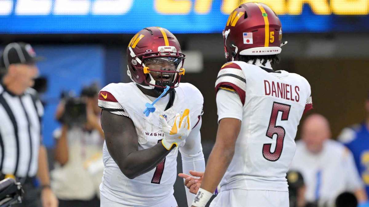 Washington Commanders quarterback Jayden Daniels (5) celebrates with wide receiver Deebo Samuel Sr. (1) after a touchdown against the Los Angeles Chargers in the second half at SoFi Stadium.
