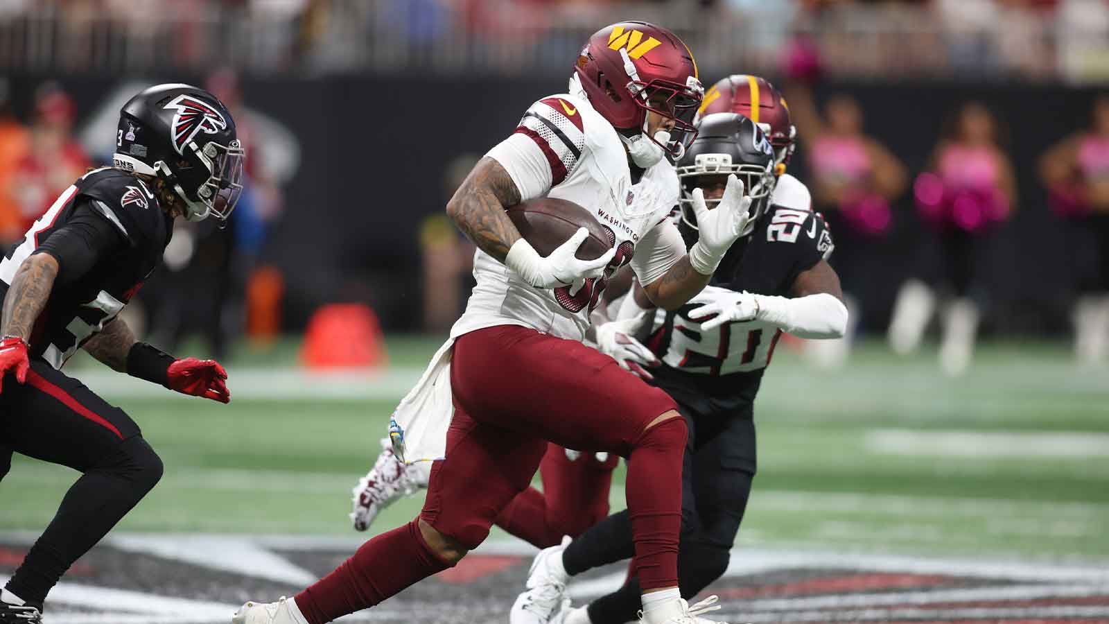 Washington Commanders running back Chris Rodriguez Jr. (36) runs against Atlanta Falcons cornerback Dee Alford (20) during the first half at Mercedes-Benz Stadium.
