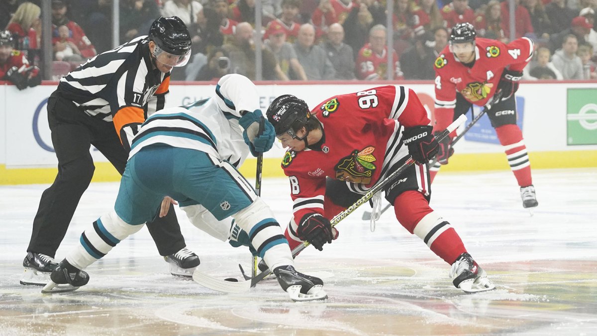 San Jose Sharks center Mikael Granlund (64) and Chicago Blackhawks center Connor Bedard (98) face off during the first period at United Center.