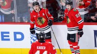 Chicago Blackhawks center Connor Bedard (98) celebrates with teammates after scoring against the Calgary Flames during the third period at United Center