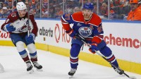 Edmonton Oilers forward Connor McDavid (97) looks to make a pass in front og Colorado Avalanche defensemen Cale Makar (8) during the third period at Rogers Place