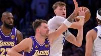 Dallas Mavericks forward Cooper Flagg (32) is defended by Los Angeles Lakers guard Luka Doncic (77) in the first half at Crypto.com Arena.