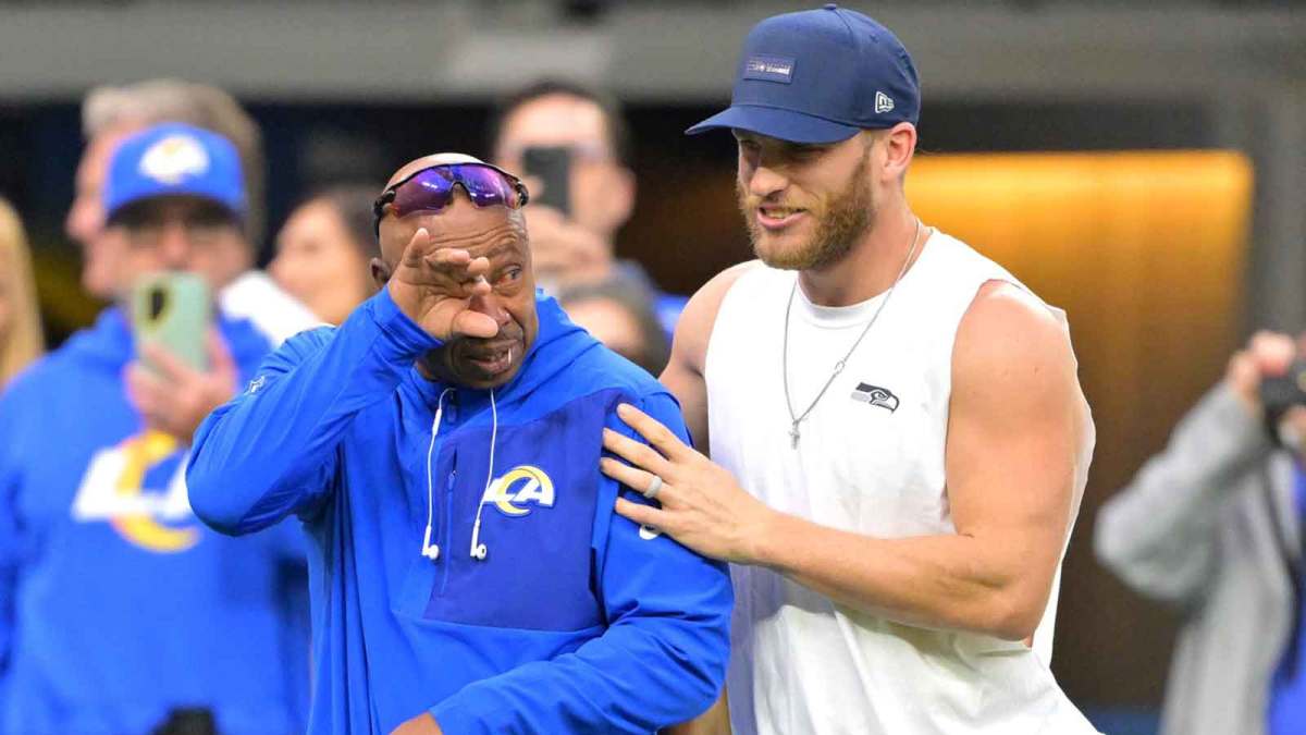 Los Angeles Rams wide receiver coach Eric Yarber, blue shirt, has an emotional reaction as he greets Seattle Seahawks wide receiver Cooper Kupp (10) on the field prior to the game at SoFi Stadium.