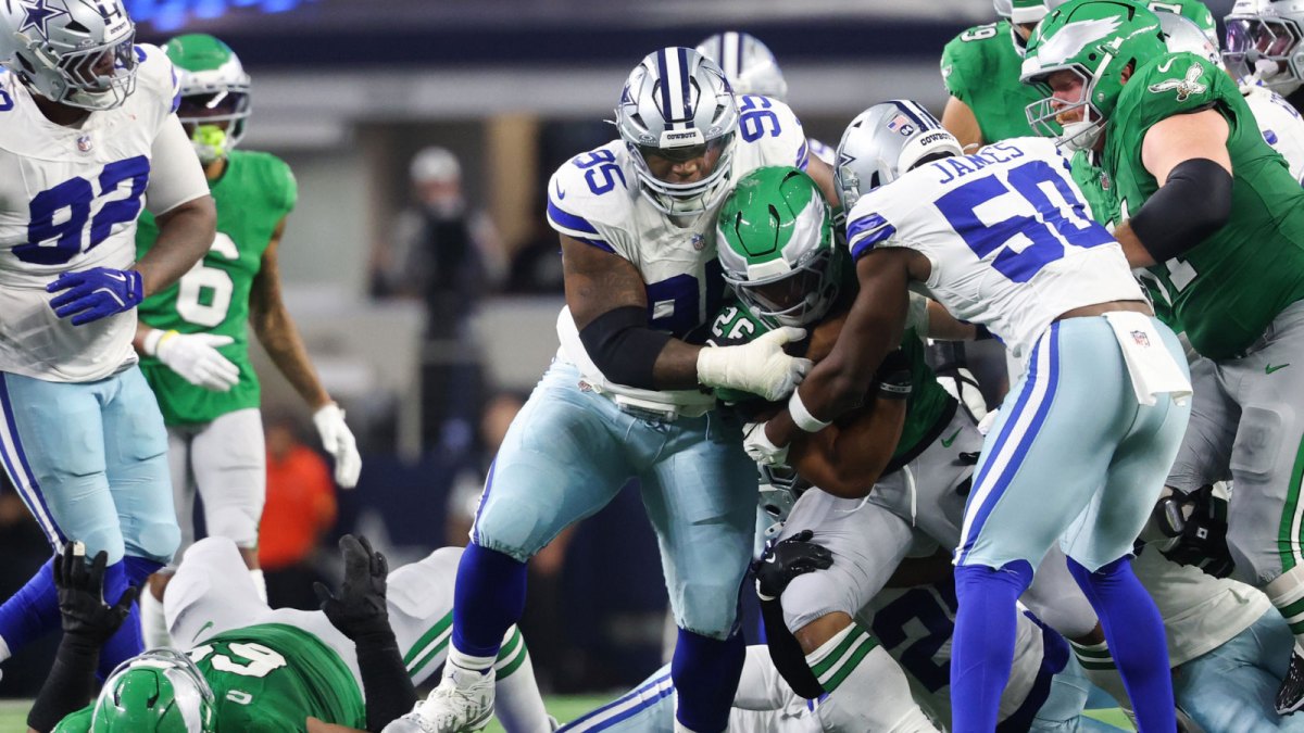 Philadelphia Eagles running back Saquon Barkley (26) is tackled by Dallas Cowboys defensive tackle Kenny Clark (95) in the third quarter at AT&T Stadium.