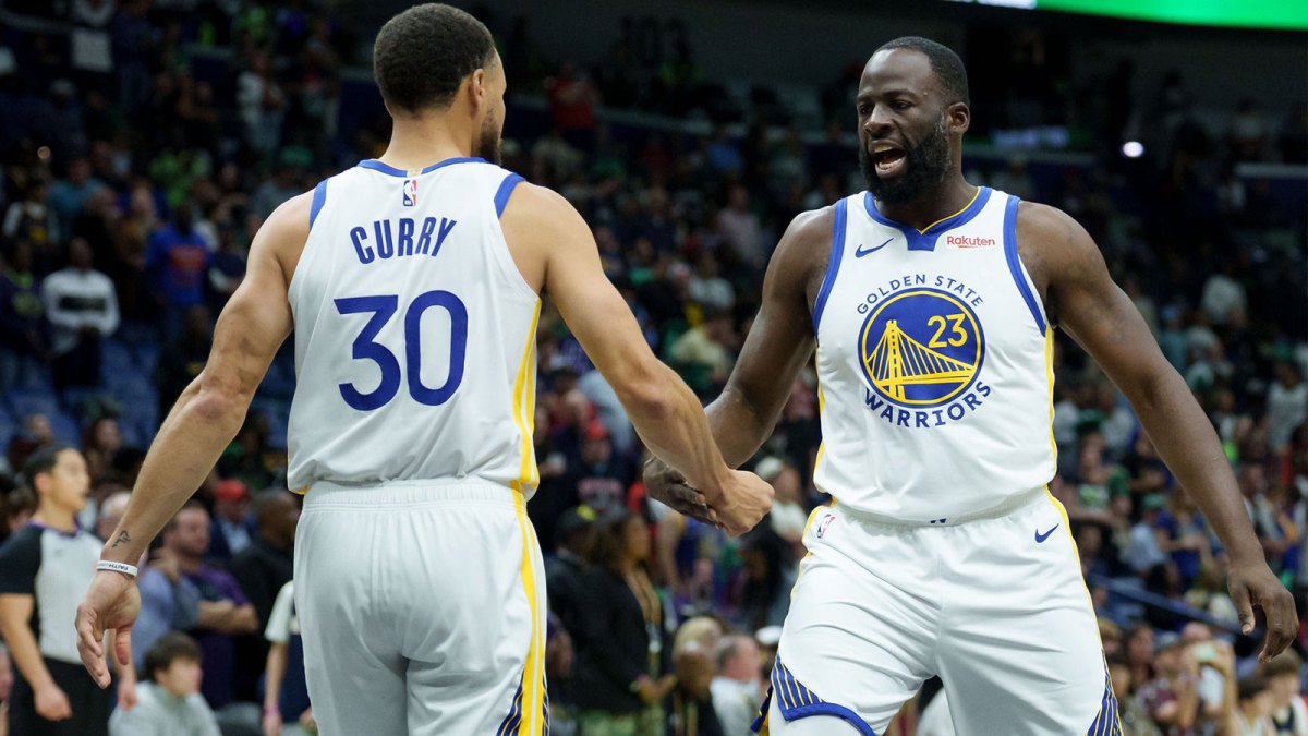 Golden State Warriors forward Draymond Green (23) celebrates with guard Stephen Curry (30) during the first half against the New Orleans Pelicans at Smoothie King Center.