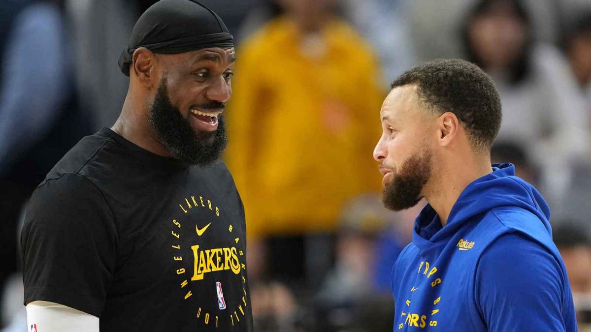 Los Angeles Lakers forward LeBron James (left) and Golden State Warriors guard Stephen Curry (right) talk before the game at Chase Center.