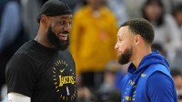 Los Angeles Lakers forward LeBron James (left) and Golden State Warriors guard Stephen Curry (right) talk before the game at Chase Center.