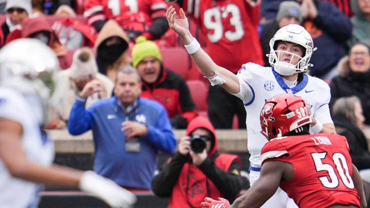 Kentucky Wildcats quarterback Cutter Boley (8) is pressured by Louisville Cardinals defensive lineman Clev Lubin (50) during the game against Louisville Saturday, November 29, 2025 in Louisville, Kentucky.