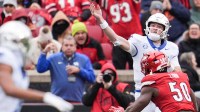 Kentucky Wildcats quarterback Cutter Boley (8) is pressured by Louisville Cardinals defensive lineman Clev Lubin (50) during the game against Louisville Saturday, November 29, 2025 in Louisville, Kentucky.