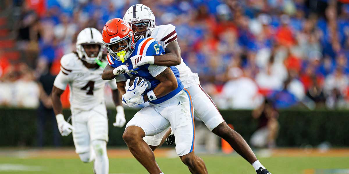Mississippi State Bulldogs safety Hunter Washington (21) tackles Florida Gators wide receiver Dallas Wilson (6) during the first half at Ben Hill Griffin Stadium.