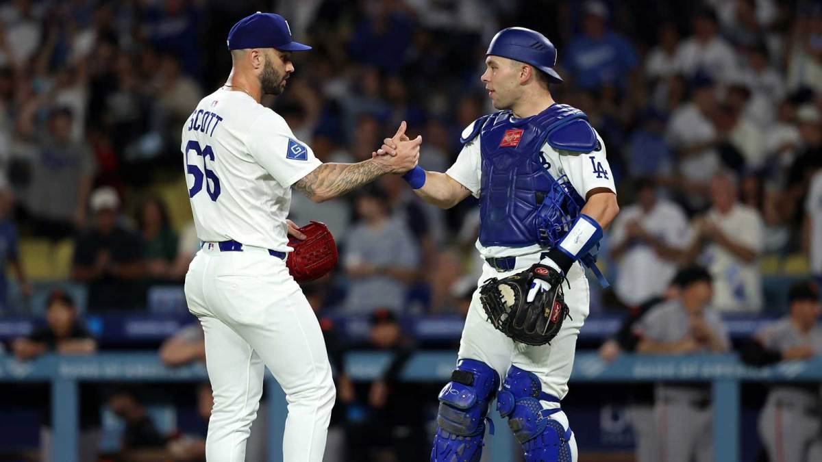 Los Angeles Dodgers relief pitcher Tanner Scott (66) and catcher Dalton Rushing (68) celebrate a win after defeating the San Francisco Giants 6-3 at Dodger Stadium.