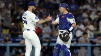 Los Angeles Dodgers relief pitcher Tanner Scott (66) and catcher Dalton Rushing (68) celebrate a win after defeating the San Francisco Giants 6-3 at Dodger Stadium.