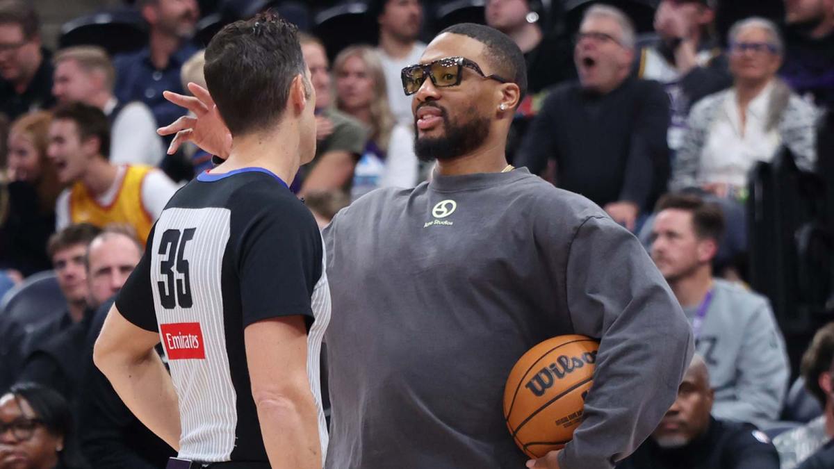 Referee Jason Goldenberg (35) speaks with Portland Trail Blazers guard Damian Lillard (right) during the second half of a game against the Utah Jazz at Delta Center.