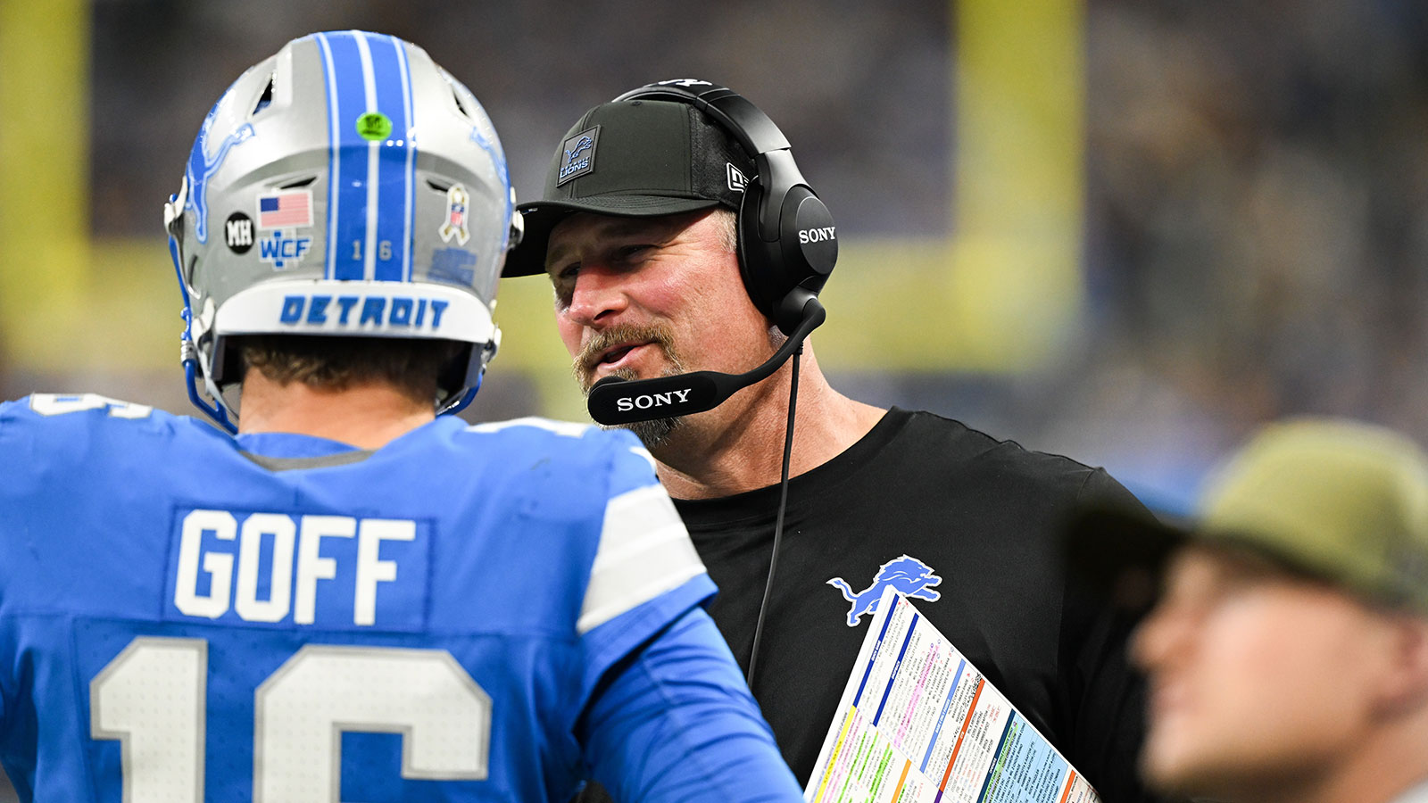 Detroit Lions head coach Dan Campbell speaks with quarterback Jared Goff (16) in the third quarter against the Minnesota Vikings at Ford Field.