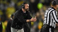 Oregon Ducks head coach Dan Lanning calls a timeout during the third quarter against the Iowa Hawkeyes at Kinnick Stadium.