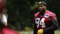 Washington Commanders defensive tackle Daron Payne (94) stands on the field on day one of minicamp at Commanders Park.