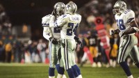 Dallas Cowboys cornerback Larry Brown (24) reacts on the field with teammates Deion Sanders (21) and Darren Woodson (28) during Super Bowl XXX against the Pittsburgh Steelers at Sun Devil Stadium. The Cowboys defeated the Steelers 27-17.