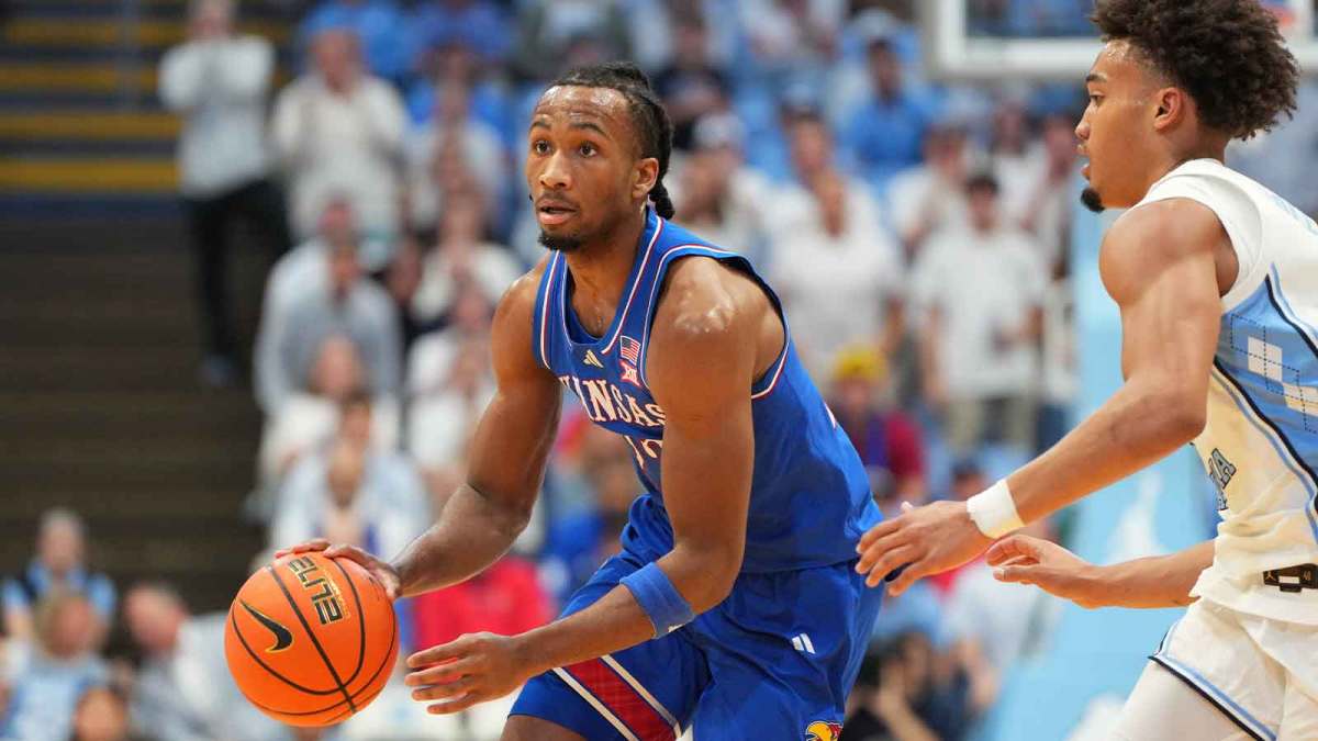 Kansas Jayhawks guard Darryn Peterson (22) dribbles as North Carolina Tar Heels guard Seth Trimble (7) defends in the first half at Dean E. Smith Center.