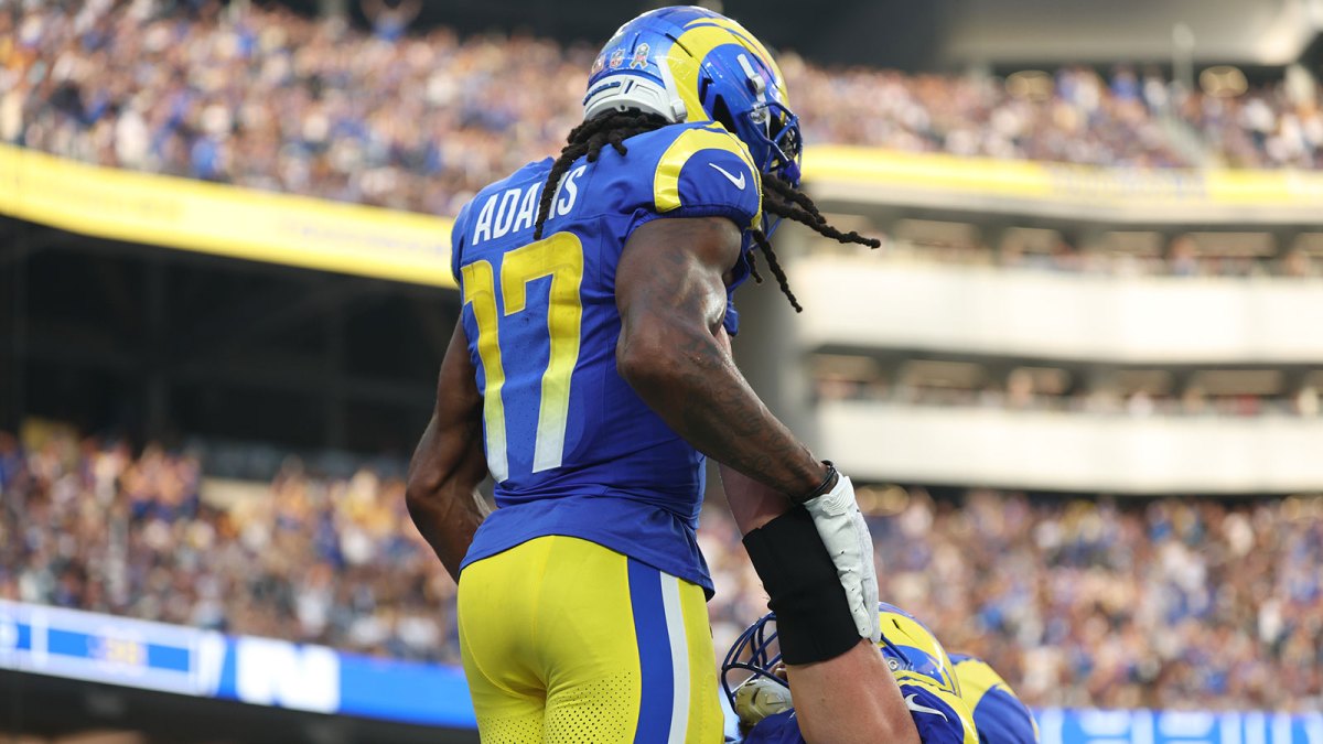 Los Angeles Rams wide receiver Davante Adams (17) is lifted up by Los Angeles Rams center Coleman Shelton (65) after scoring a touchdown New Orleans Saints during the second half at SoFi Stadium.