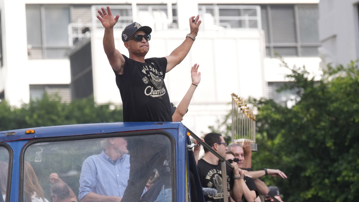 Los Angeles Dodgers manager Dave Roberts waves to fans during the World Series championship parade and celebration.