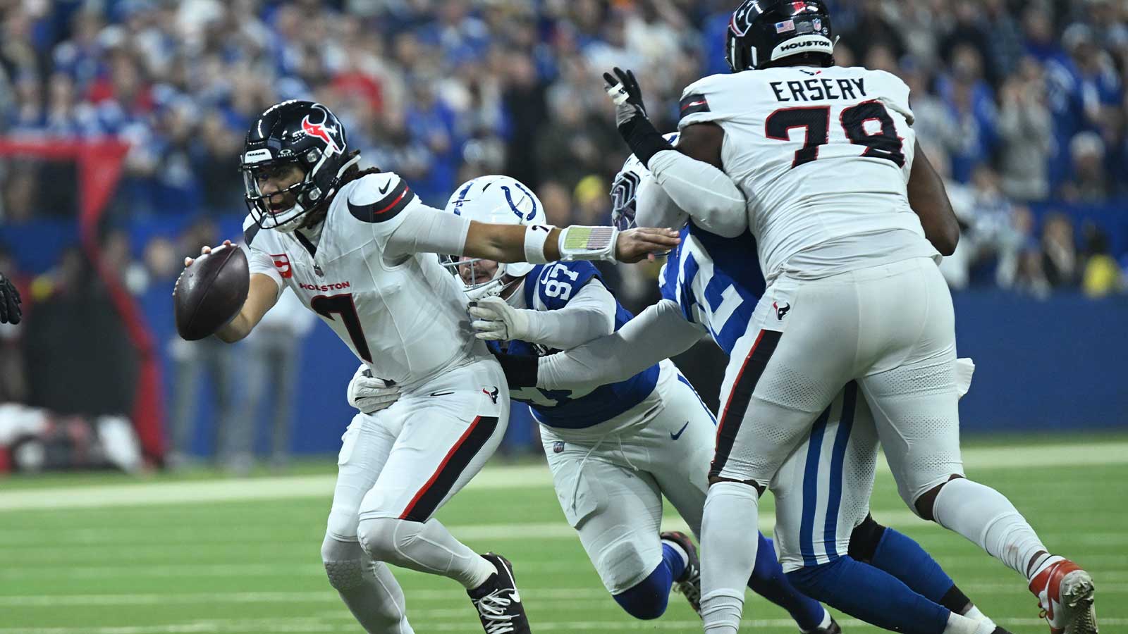 Houston Texans quarterback C.J. Stroud (7) scrambles against Indianapolis Colts defensive end Laiatu Latu (97) during the first half at Lucas Oil Stadium.