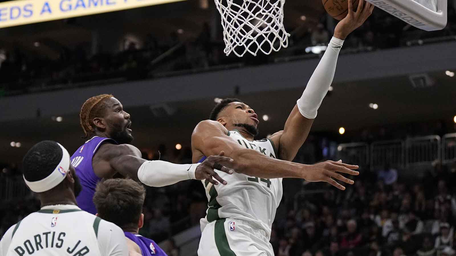 Milwaukee Bucks forward Giannis Antetokounmpo (34) shoots in front of Los Angeles Lakers center Deandre Ayton (5) during the second quarter at Fiserv Forum.