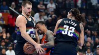 Los Angeles Clippers forward John Collins (20) moves the ball against Denver Nuggets center Nikola Jokic (15) and forward Aaron Gordon (32) during the first half at Intuit Dome.