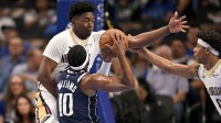 Dallas Mavericks guard Brandon Williams (10) attempts to drives to the basket against New Orleans Pelicans center Derik Queen (22) and guard Jeremiah Fears (0) during the first quarter at the American Airlines Center.