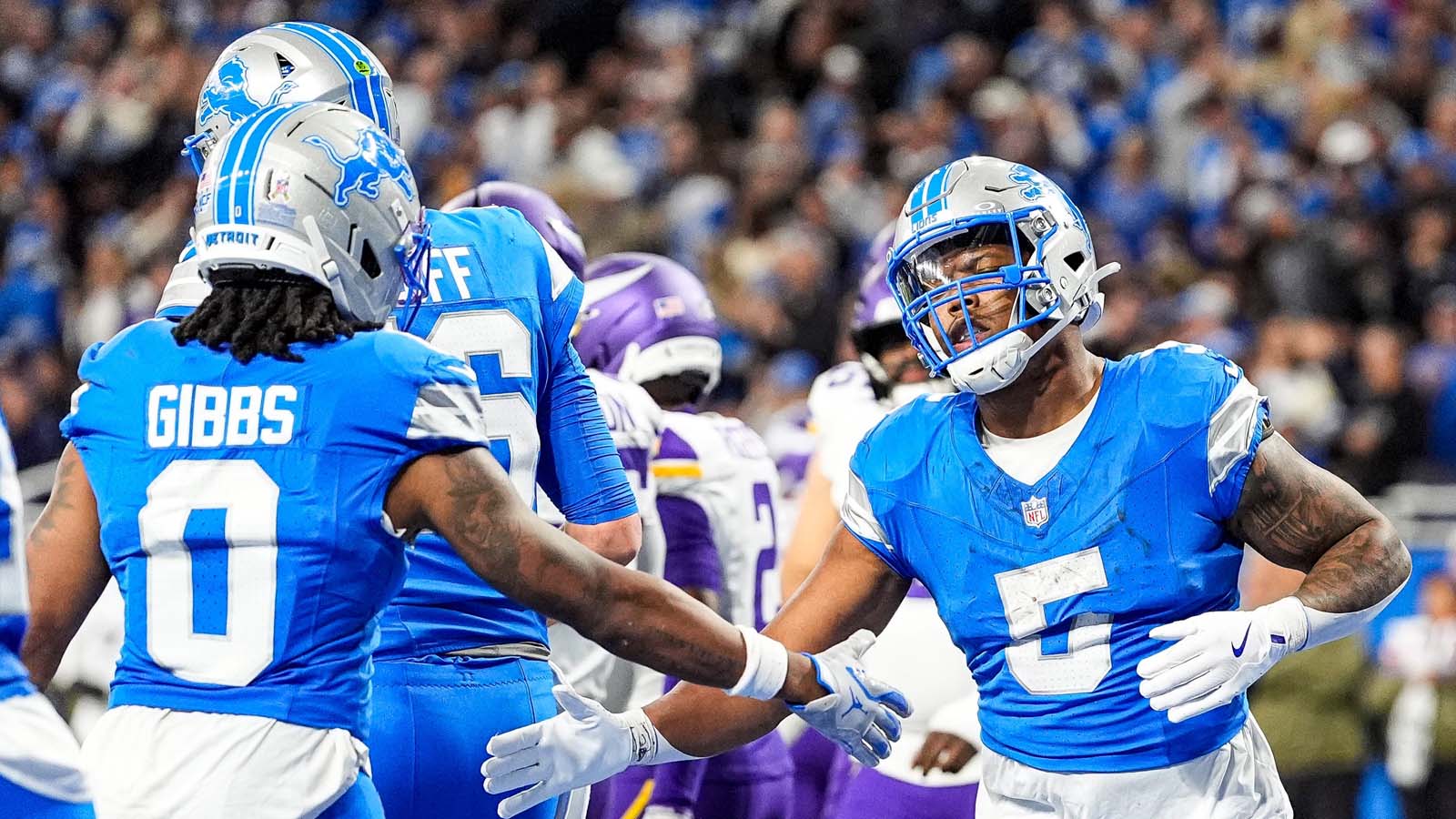 Detroit Lions running back David Montgomery (5) celebrates a touchdown against Minnesota Vikings with running back Jahmyr Gibbs (0)