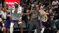 Phoenix players Jalen Green, in street clothes, Devin Booker, and Mark Williams cheer on teammate Grayson Allen as they play against the New Orleans Pelicans at Mortgage Matchup Center on Nov. 10, 2025.