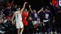 Phoenix Suns guard Devin Booker (1) reacts after scoring against the Portland Trail Blazers to make Booker the Suns’ all-time leading scorer in the second half at Moda Center.