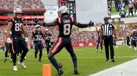 New England Patriots wide receiver Stefon Diggs (8) celebrates a touchdown with tight end Hunter Henry (85) during the second quarter against the Tampa Bay Buccaneers at Raymond James Stadium.